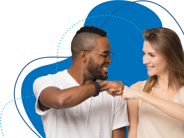 A man and woman fist bump, smiling at eachother