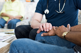 A doctor taking a patients pulse