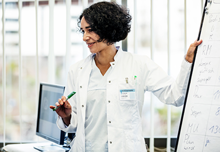 Woman standing in white lab coat
