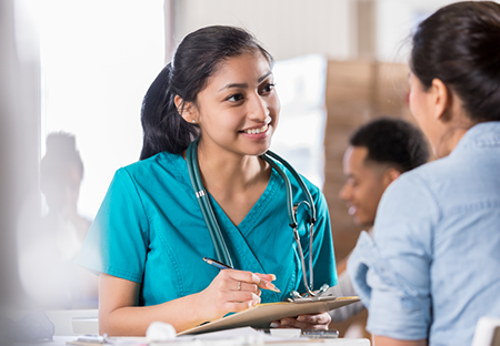 Female healthcare worker charting a patient