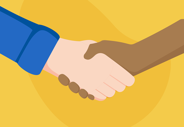 A white and a black hand shaking