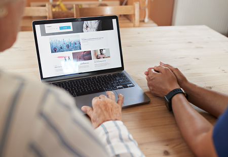 Two people using a laptop