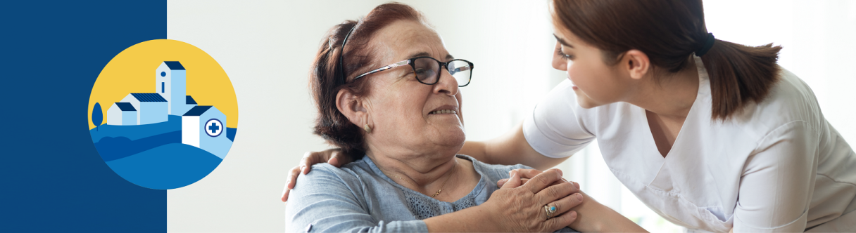 A young female nurse embracing an elderly woman