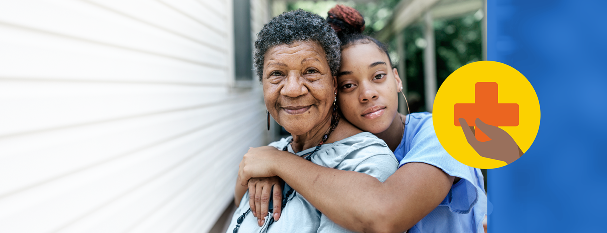A young woman hugging an elderly woman around her shoulders with the elderly woman smiling