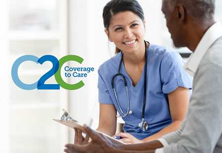 Smiling nurse with clipboard and stethoscope smiles at patient