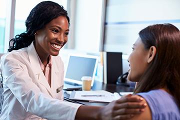 Image showing care provider in white lab coat consulting with a patient
