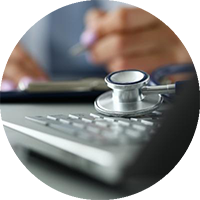 Hands and stethoscope on table surface