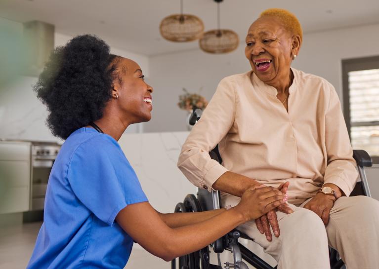 Nursing tending to a patient in a wheelchair